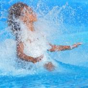 children sliding down a water slide